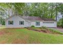 Exterior of a one-story home with green shutters, showing a well-maintained lawn and an attached garage at 2088 Blackberry Ln, Auburn, GA 30011