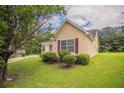 The home boasts a spacious lawn, mature trees, and neutral siding at 3673 Jervis Ct, Rex, GA 30273