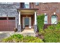 Inviting front porch with stone pillars and manicured landscaping, offering a warm welcome at 3642 Lake Estates Way Way, Atlanta, GA 30349