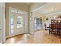 Bright foyer with hardwood floors leading to a dining room with elegant decor and natural light at 414 Wallis Farm Way, Marietta, GA 30064