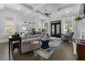 Open-concept living room with coffered ceilings, fireplace, and access to the outdoor space at 570 Society St, Alpharetta, GA 30022