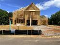 Two-story home under construction featuring wood framing and exposed beams at 675 Crest Line Trl, Powder Springs, GA 30127