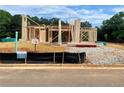 New home under construction showing the wood framing on a sunny day at 675 Crest Line Trl, Powder Springs, GA 30127