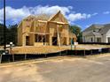Two-story home under construction with wood framing, located in a new community at 675 Crest Line Trl, Powder Springs, GA 30127