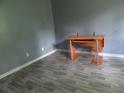 Bedroom with gray walls, gray wood-style floors and a wooden desk at 1993 Whitehall Forest Ct, Atlanta, GA 30316