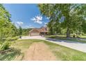 A charming house with a large lawn, covered porch, three-car garage, and ample parking space at 3040 Sandy Creek Ct, Loganville, GA 30052