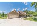 Lovely exterior featuring a three-car garage, covered porch, fenced yard, complemented by a concrete driveway at 3040 Sandy Creek Ct, Loganville, GA 30052