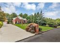 Charming two-story brick home featuring lush green lawn, manicured landscaping, and attached two-car garage at 4119 Alayna Lee Cir, Mcdonough, GA 30252