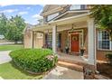 Inviting front porch with brick steps, decorative wreath, and charming curb appeal at 6597 River Island Drive Dr, Buford, GA 30518