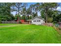 Scenic exterior showcasing a well-manicured lawn, mature trees, and a charming home with a backyard at 1564 Belva Ave, Decatur, GA 30032