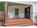 Inviting front porch with a small table set, and freshly painted white trim, offering a cozy outdoor space at 1564 Belva Ave, Decatur, GA 30032