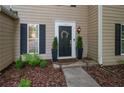 Charming front entrance with a black door, decorative wreath, and manicured landscaping at 5679 Bay Harbor Nw Trl, Acworth, GA 30101
