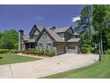 Spacious home with a three-car garage, long driveway, and well-maintained landscaping at 1231 Fawndale Nw Dr, Kennesaw, GA 30152