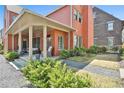 Charming brick home with a covered patio featuring comfortable outdoor seating and manicured landscaping at 175 Central Ave, Fayetteville, GA 30214