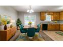 Dining area features a table with seating for six, with an open transition to the kitchen at 3694 Rolling Pl, Conley, GA 30288