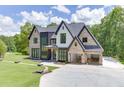 Beautiful exterior view of a modern two-story home with a large driveway and well-maintained garden at 4459 Grady Smith Rd, Loganville, GA 30052