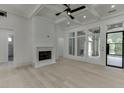 Open-concept living area with fireplace, coffered ceilings, large windows, and access to a patio at 4459 Grady Smith Rd, Loganville, GA 30052