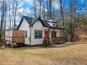 Beautifully designed home featuring a bright orange door and a spacious wooden deck for outdoor living at 5728 Williams Rd, Norcross, GA 30093