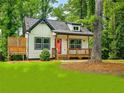 Inviting cottage-style home with cozy front porch and landscaped lawn at 5728 Williams Rd, Norcross, GA 30093
