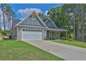 Beautiful one-story home with a two-car garage, stone veneer, and well-manicured lawn at 145 Millennial Ct, Lawrenceville, GA 30045