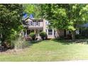 Traditional home with well-maintained lawn and mature trees at 2889 Carrousel Ct, Stone Mountain, GA 30087