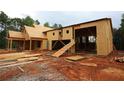 Exterior view of a two-story home under construction, featuring wood framing and an incomplete garage at 578 Price Rd, Carrollton, GA 30116
