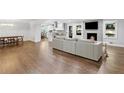 Spacious living area with wood floors, fireplace, and seamlessly connects to a modern kitchen and dining area at 2445 Kings Point Dr, Dunwoody, GA 30338