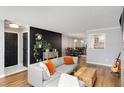 Open-concept living space with hardwood floors, stylish decor, and seamless flow into dining area is designed for modern living at 303 Gettysburg Pl, Atlanta, GA 30350