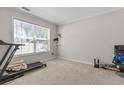 Carpeted room with large window, providing ample natural light and a view to the outside at 3234 Baymount Way, Lawrenceville, GA 30043