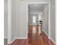 Hallway showcasing hardwood floors and a view into a bright and airy living space at 3234 Baymount Way, Lawrenceville, GA 30043
