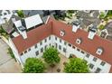 Birds eye view of a residential building with a central courtyard featuring lush greenery and dark gray slate tiled roof at 11277 Serenbe Ln, Chattahoochee Hills, GA 30268