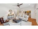 Inviting living room with hardwood floors, a gray ottoman, and views into kitchen area at 1383 Fenway Cir, Decatur, GA 30030