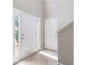 Bright foyer with neutral walls, tile flooring, and natural light streaming through the front door's sidelight at 3732 Landgraf Cv, Decatur, GA 30034