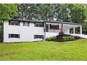 Inviting single-Gathering home with a brick facade, well-maintained lawn, and convenient covered parking at 4651 Palm Dr, Douglasville, GA 30135