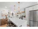 Bright kitchen featuring an island with a quartz countertop and stainless steel appliances at 1062 Sasha Ln, Roswell, GA 30075