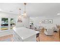 Open kitchen flows to a living space with new lighting and breakfast bar at 1062 Sasha Ln, Roswell, GA 30075