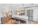 Bright kitchen featuring an island with a quartz countertop and stainless steel appliances at 1062 Sasha Ln, Roswell, GA 30075