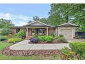Inviting brick home featuring a lush front garden and walkway leading to the charming entrance at 236 Ridge Nw Ave, Marietta, GA 30064