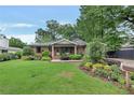 Charming brick home with a well-manicured lawn and lush landscaping adding curb appeal at 236 Ridge Nw Ave, Marietta, GA 30064