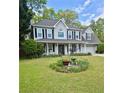 Beautiful two-story home featuring a landscaped front yard and inviting porch at 25 Jessamine Trail Trl, Lawrenceville, GA 30046