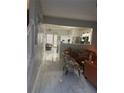 Open-concept living room with modern tile flooring and views into the kitchen and breakfast nook at 2735 Parkway Trl, Lithonia, GA 30058