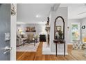 Open floor plan living room with fireplace, hardwood floors, and comfortable seating at 3408 Lake Pointe Cir, Roswell, GA 30075
