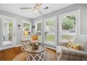Inviting sunroom with a ceiling fan and plantation shutters at 3408 Lake Pointe Cir, Roswell, GA 30075