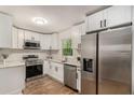 Modern kitchen with stainless steel appliances, white cabinets, and granite countertops at , Atlanta, GA 30354