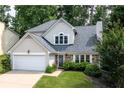 Charming home with stone accents, well-maintained lawn, and attached two-car garage at 1005 Wellers Ct, Roswell, GA 30076