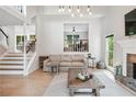 Bright living area with fireplace, wooden accents and access to a second-story landing at 1005 Wellers Ct, Roswell, GA 30076