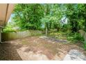 A spacious backyard with a wood fence, mature trees, and a patio, perfect for outdoor activities at 1381 Benteen Way Southeast, Atlanta, GA 30315