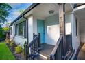 Welcoming front entrance features a bright blue door, black railings, and fresh landscaping at 1398 Woodland Ave, Atlanta, GA 30316