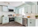 Modern kitchen featuring stainless steel appliances, light blue cabinets, and marble countertops at 2343 Dawn Dr, Decatur, GA 30032