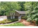 Charming home featuring stone accents and gray trim, surrounded by lush landscaping and mature trees at 2717 Hearthstone Cir, Marietta, GA 30062